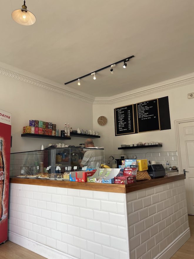 Wide view of the white tiled counter and display cabinet