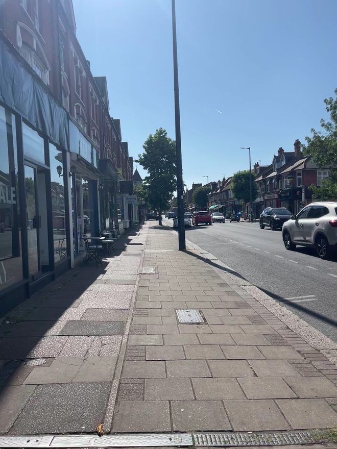The parade of shops along Upper Richmond Road West under a clear sky